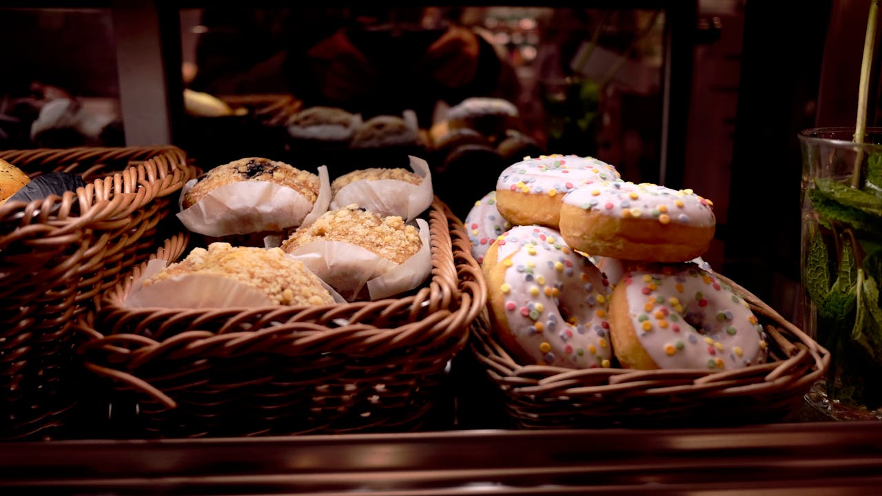 White Topped Doughnut Beside Peanut Cupcake