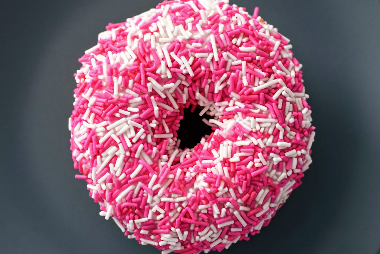 Doughnut With White and Pink Sprinkles